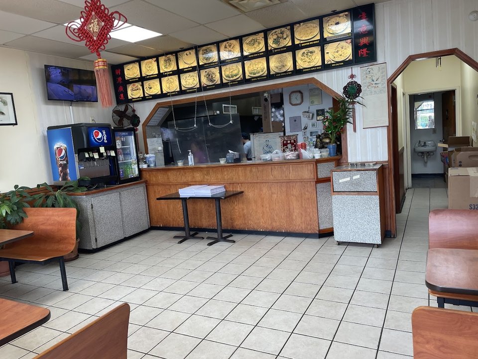 Casual interior with plain seating and menu boards.